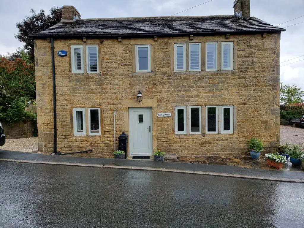 Yorkshire stone house with white flush casement windows on every floor