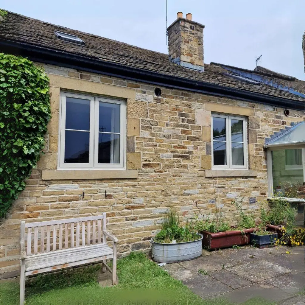 White flush casement window in stone cottage
