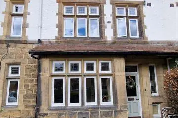 Bay and casement windows on a painted stone property