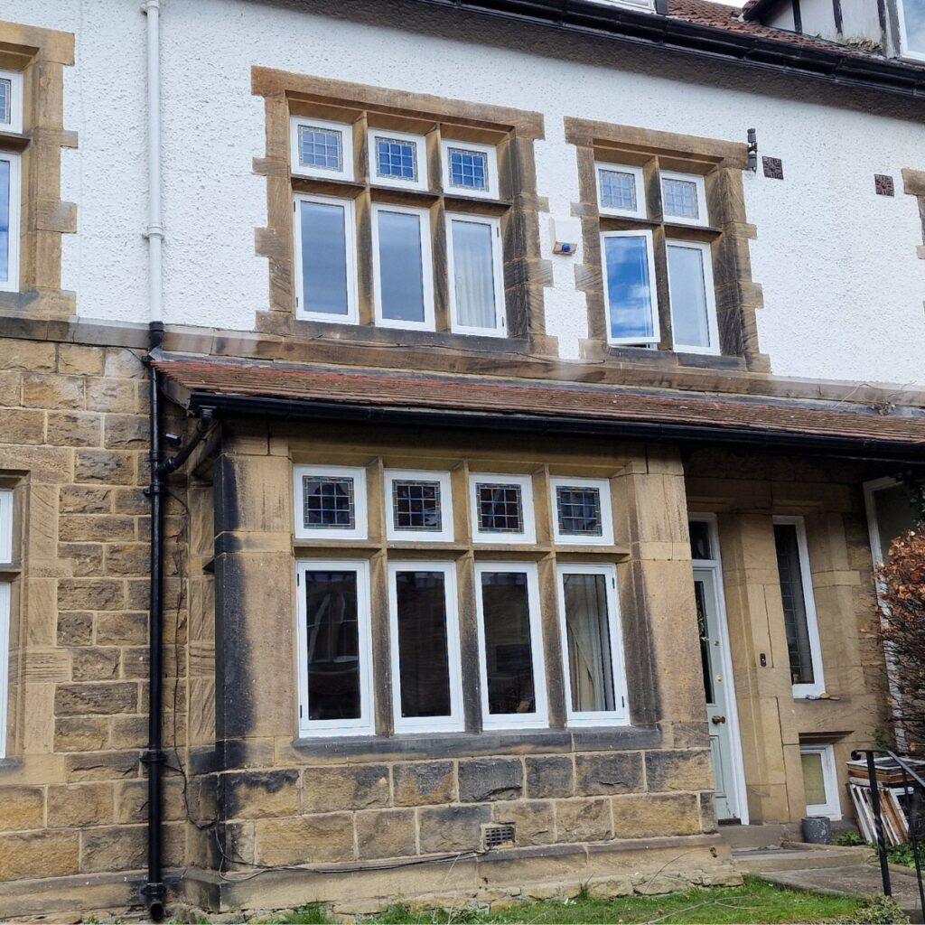 Yorkshire stone cottage exterior with timber windows, Farrar Joinery installation